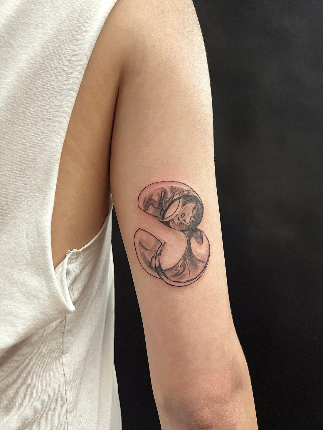Abstract fluid blackwork tattoo on arm designed with movement and body flow by Melbourne tattoo artist Mr Inking Tattoo