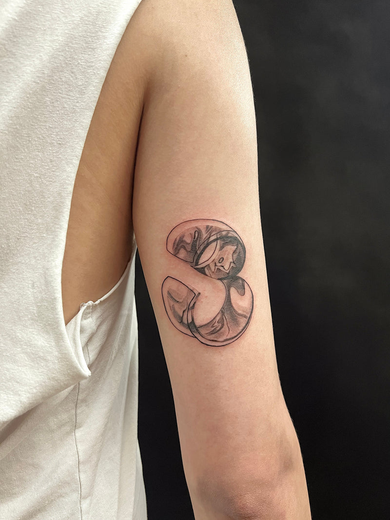 Abstract fluid blackwork tattoo on arm designed with movement and body flow by Melbourne tattoo artist Mr Inking Tattoo